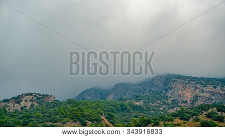 Beautiful Mountains Aerial Landscape View. Mountain Peak Of Rocks Covered By Clouds And Fog. Mountai