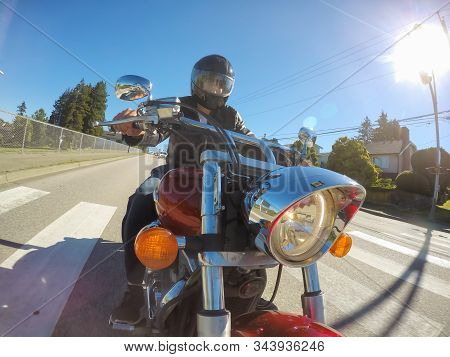Vancouver, British Columbia, Canada - July 08, 2018: Man On A Motorcycle Is Riding In A Modern City 