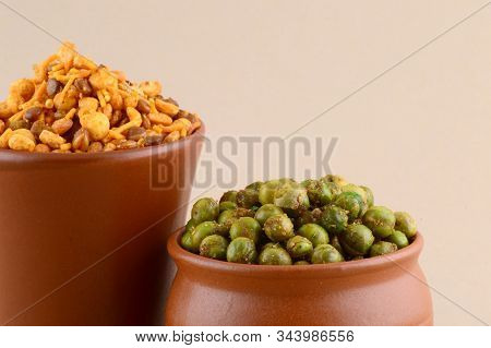 Indian Snack: Mixture And Spiced Fried Green Peas {chatpata Matar} In Clay Pots.