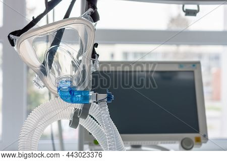 Non-invasive Ventilation Face Mask, On Background Medical Ventilator In Icu In Hospital.