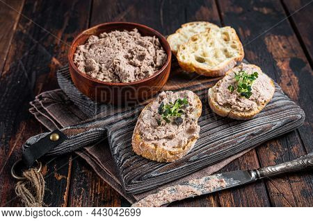 Toasts With Duck Pate Rillettes De Canard On Wooden Board. Dark Wooden Background. Top View