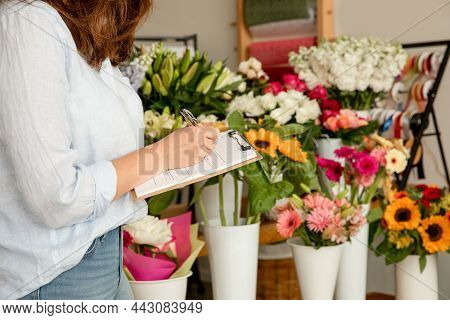 Small Business. Female Florist Taking Orders In Flower Shop. Floral Design Studio, Making Decoration