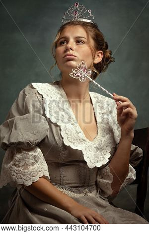 Close-up Portrait Of Young Beautiful Girl In Gray Dress Of Medieval Style Isolated On Dark Backgroun
