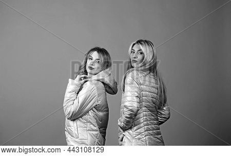 Fashion And Creative Portrait Of Two Beautiful Sexy Women In Identical Gray Jackets.
