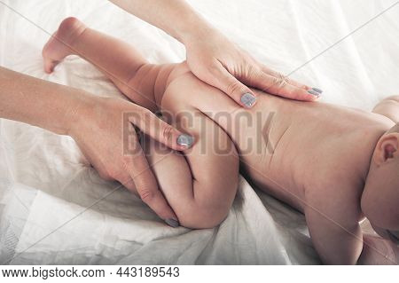 Newborn Baby And Mother's Hands Close Up And Copy Space. Child 5 Months Old Massage, Colic, Teething