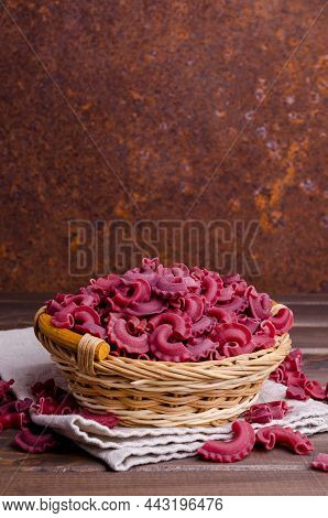 Dry Traditional Beetroot Pasta. Wooden Background. Top View.