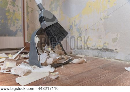 Clean Up Garbage After Repairs.sweep Up Construction Debris With A Brush In A Dustpan.sweeping At Ho