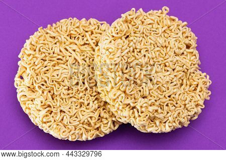 Uncooked Instant Noodles On Violet Background. Raw Pasta. Dry Asian Fast Food. Quick Lunch