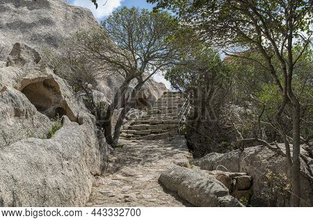 Stairs From Raw Stones And Rocks With Tree And Plants In Garden Sardinia Near Palua, The Stiars Lead
