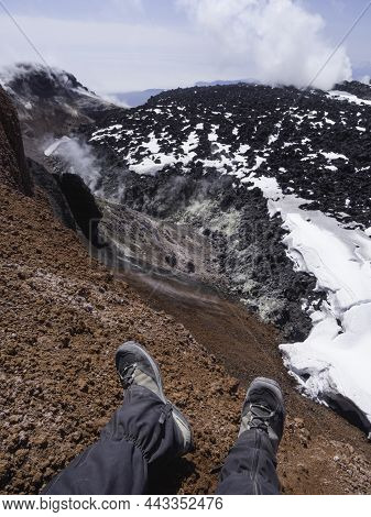 Top View On Mans Feet In Hiking Boots At Caldera Of Avachinsky Stratovolcano, Also Known As Avacha V
