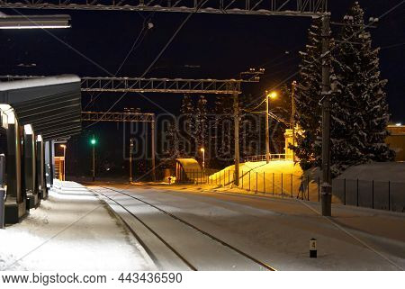 Snow Covered Train Platform At Night. Estonia Lockal Train Station. Close Up