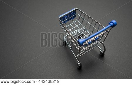 Small Supermarket Grocery Push Cart For Shopping Toy With Wheels Isolated On Dark Colourful Trendy M