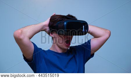 An Excited Young Guy In Virtual Reality Glasses Is Immersed In The Metaverse