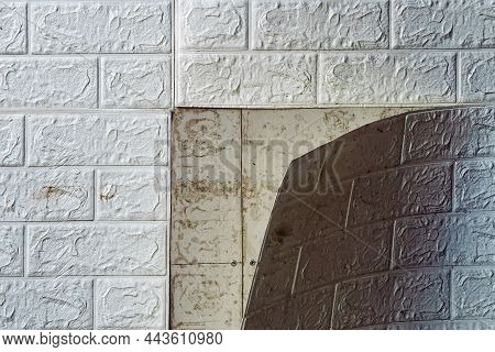 The Wallpaper Begins To Peel Off. Old White Bricks Wallpaper Peeled Off From The Wall Inside The Roo