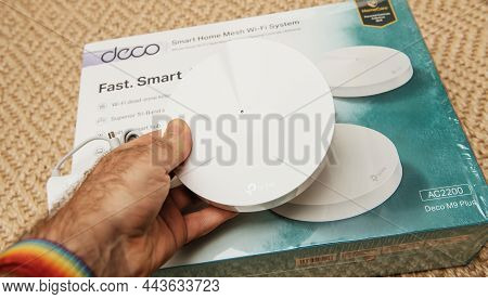 Paris, France - Nov 17, 2020: Pov Male Hand Holding New Deco Tp-link Mesh Internet Smart Home Wifi S