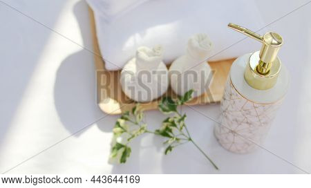 Spa Concept Includes White Towels And Liquid Soap Bottles, Flowers And Aloma Fragrance Oils Put On A