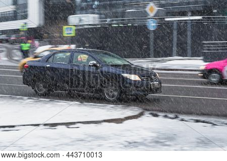 Car Toyota Corolla E140 Is Driving Fast On Winter Wet And Slippery Street. Blue Sedan Toyota Auto In