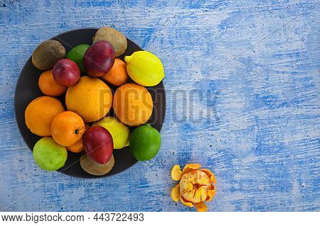 Citrus Fruits On Navy Concrete Pattern. Assorted Citrus Fruits And Tamarillo. Kiwi On Vintage Table 