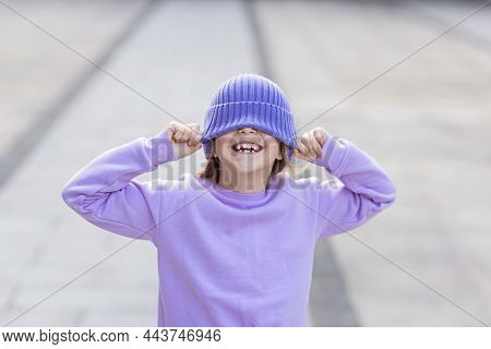 Cute Little Caucasian Girl Eight Years Old With Blonde Hair Smiling Outdoor. Kid Wearing Stylish Shi