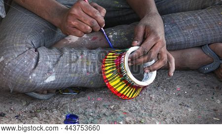 A Painter Painting The Mud Pot For The Diwali Festival.