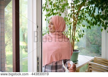 Gorgeous Arabic Muslim Woman Wearing Hijab, Enjoys Spring Cleaning In The House On A Beautiful Sunny