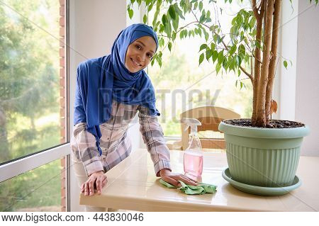 Delightful Gorgeous Charming Middle Aged Arabic Muslim Woman With Covered Head In Blue Hijab Wiping 