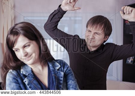 Young Caucasian Couple Squarrel With Lifted Hands Demonstrating Violence. Horizontal Image Orientati