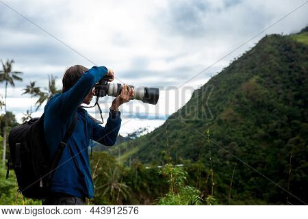 Tourist Taking Pictures At The Beautiful Valle De Cocora Located In Salento At The Quindio Region In