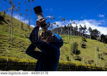 Tourist Taking Pictures At The Beautiful Valle De Cocora Located In Salento At The Quindio Region In