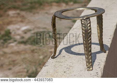Stock Photo Of Ancient Style Handmade Brass Three Legged Ring Center Stand Or Stool Kept On Wall Und