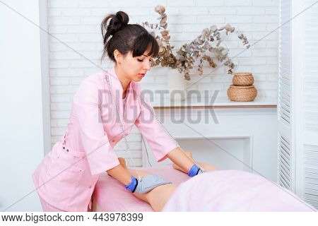 Masseuse Makes An Anti-cellulite Massage On Legs. Micro-sensory Electric Micro-current Procedure Bio