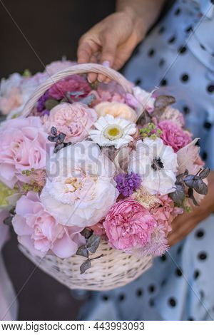 Beautiful Bouquet Of Flowers In Basket, Woman Hands. Wicker Basket With Preserved Flowers. Floristry