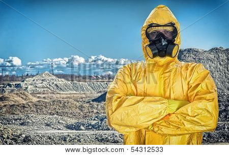 Worker In Protective Chemical Suit Over Mountains.