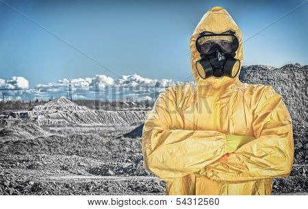 Worker In Protective Chemical Suit Over Mountains.