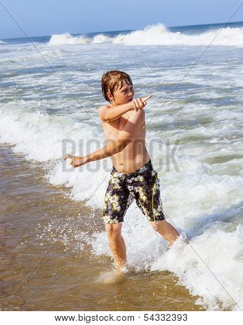 Boy In Motion At The Sea