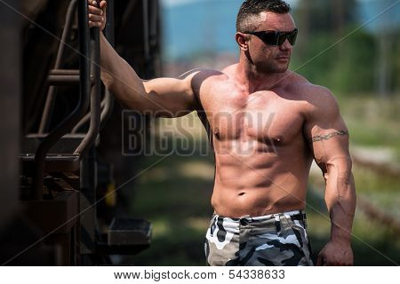 Male Bodybuilder Holding On To Train