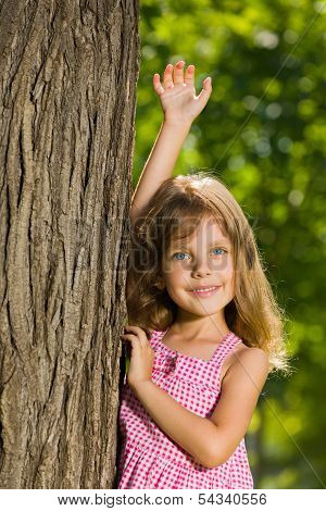 Pretty Little Girl Near A Tree