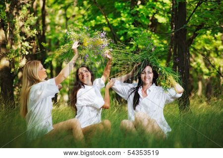 three friend girl playing on grass. outdoor shot