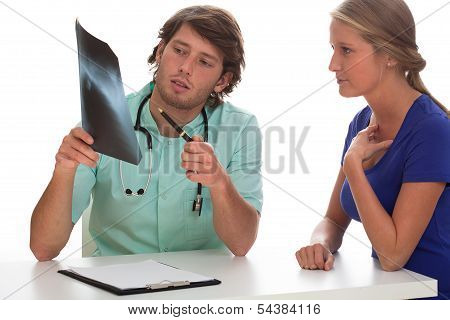 Doctor Showing X-ray Photo To His Patient.