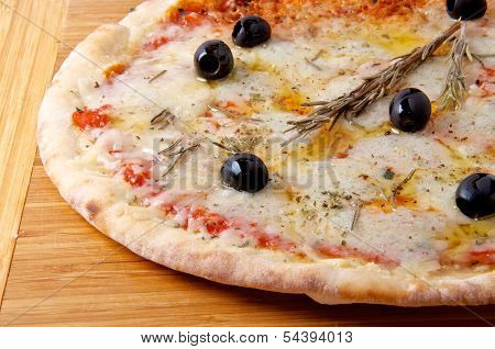 Pizza quattro fromaggi 4 cheese on a wooden board