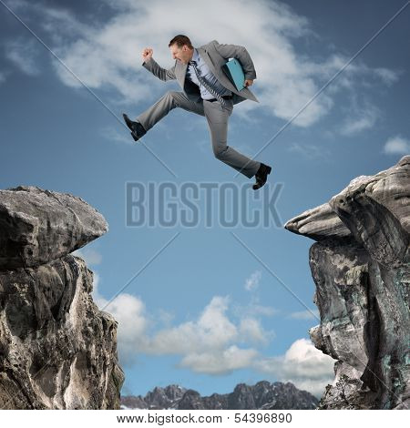 Businessman leap of faith concept for business adversity, risk or challenge