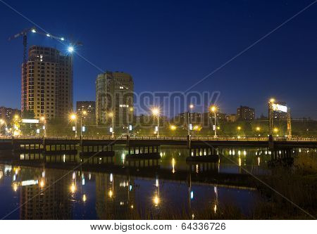 Night Scene With Illuminated Bridge Over River In Donetsk