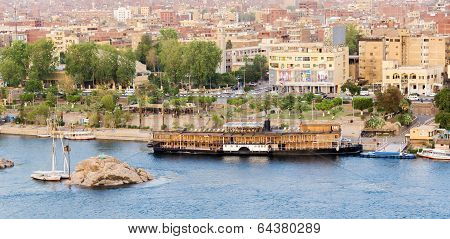 Nile River by Aswan City skyline with Boats
