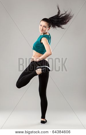 Professional dancer in studio on grey background