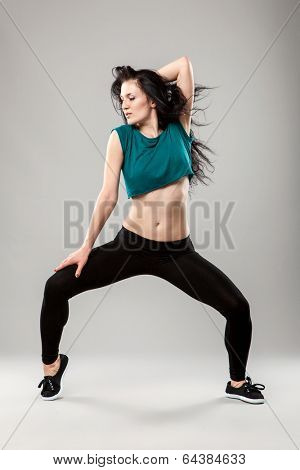 Professional dancer in studio on grey background