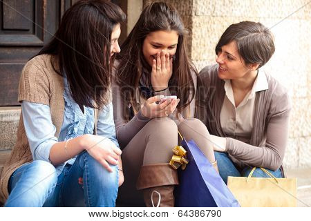 Happy Girls Messaging With Mobile Phone After Shopping