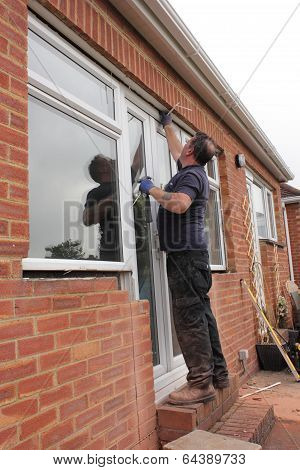 A Window fitter removing old windows