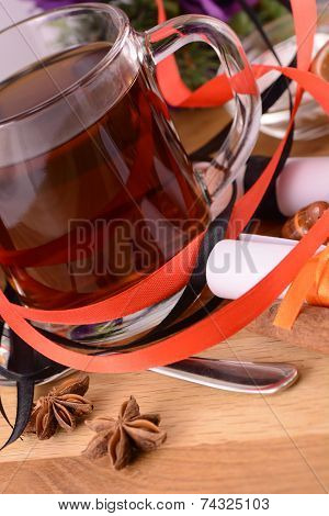 Hot Tea With Lemon And Cinnamon On Wooden Backgroubd