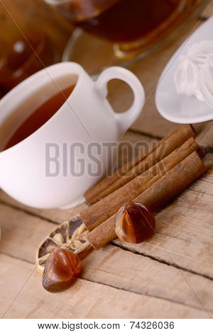 Hot Tea With Lemon And Cinnamon On Wooden Backgroubd
