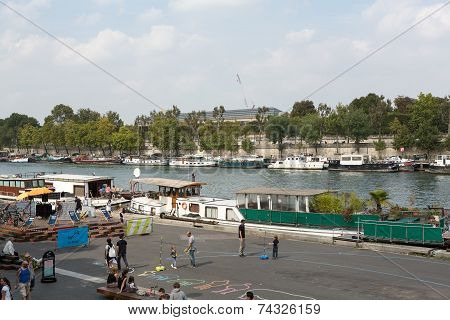 Paris - tourists walk with the bank of Seine at the bridge Solferino
